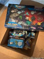 Box with multiple Playmates Star Trek Micro Machines sets visible, mostly in original boxes inside a larger cardboard box.
