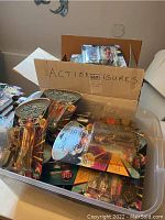 Plastic storage bin and open cardboard box filled with multiple Star Trek: TNG figures in sealed blister-card packaging