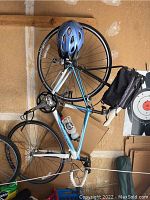 Trek road bicycle with helmet hanging on hook in garage