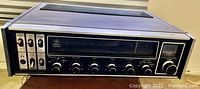 General Electric Stereo Receiver with wood side panels, front controls, and tuning dial.