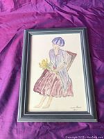 Full view of framed hand painted artwork of a seated woman with a bouquet of flowers.