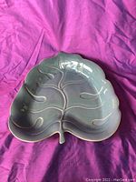 Top view of large leaf shaped teal ceramic platter showing leaf vein details and organic edges