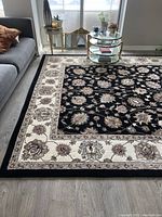 Full view of rug laid out in living room showing overall pattern and condition