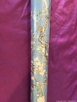 Rolled Van Gogh Almond Blossom poster in original sealed packaging, showing part of the blue background with white and pink almond blossoms.