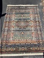 Full view of the rug laid flat, showing overall pattern, size, and condition