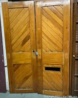 Pair of wooden doors showing both the light wood finished door and the brown painted door side by side with diagonal panel designs.