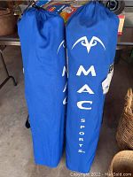 Two blue carry bags standing side by side, each with Mac Sports logo and branding visible.