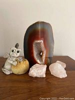 Full lot showing Brazilian agate geode, dragon figurine, and pink Himalayan salt crystals.