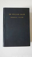 Photo of the book front cover showing black hardcover with gold lettering.