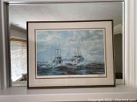 Framed print showing maritime scene of two ships on rough sea under cloudy sky.