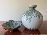 Photo showing both the ceramic vase and the pottery bowl side by side on a wooden surface.