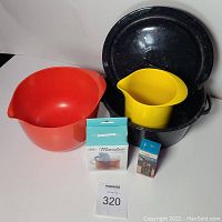Photo showing two Rosti Denmark mixing bowls (red large and yellow small), black speckled enamel pot with lid, brand new tea strainer box, vintage timer box and a small tealight box