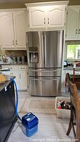 Full front view of stainless steel Samsung French door refrigerator in kitchen