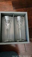Pair of Waterford Millennium Collection champagne flutes in original box with cut crystal design