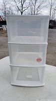 Front view of the white plastic 3-drawer storage tower showing closed transparent drawers.