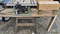Full view of Delta 10 table saw on wooden bench showing setup and construction