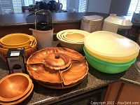 Photo of all items on countertop showing lazy Susan, bowls, juicer, grater, and appliances.
