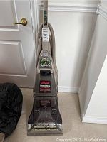 Full view of Hoover SteamVac Widepath upright vacuum cleaner with hose and powered hand tool attachment.