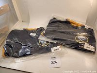 Two Buffalo Sabres track jackets in navy, sealed in individual plastic bags showing original tags and labels.
