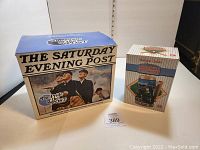 Photo of the Saturday Evening Post box and Budweiser stein box, showing both items in original packaging.