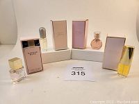 Full lot shown with four boxed mini perfumes and bottles displayed.
