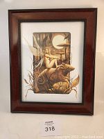 Front view of framed print showing the fairy sitting on rodent under full moon