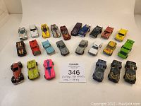 Full view of all 21 vintage Hot Wheels cars arrayed in three rows on white background. Shows the variety of colors, models, and condition indicating play wear.