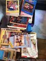 Stack and spread of paperback books with focus on Babysitters Club series by Ann M. Martin, colorful covers with youth characters