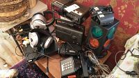Overall lot view showing headphones, radios, vintage phone, and novelty traffic light on a table