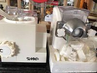Side view of two white pasta makers and a juicer, close up on the Maverick logo on one pasta maker