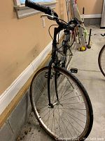 Front view of black Crossroads Specialize bicycle with 19 inch frame and 27 inch wheels, showing handlebars, front fork and wheel.