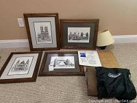 All items arranged on floor including four framed prints, folded air mattress, Lincoln writings, and lamp