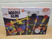 Box showing the Elevator Marble Run toy set with colorful tracks and motorized elevator