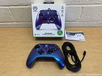 Photo of the packaged PowerA Enhanced Wired Xbox Controller box with controller and manual next to it.