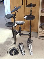 Full assembled drum kit showing module, pads, cymbals, rack, pedals and cables