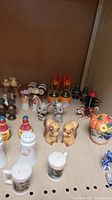 Photo showing varied themed salt and pepper shakers including animals (mice, squirrels, dogs), fire hydrant, cowboy boots, and barrels.