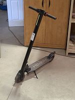 Full view of the Hover-1 electric scooter showing the handlebar, stem, deck, and wheels.