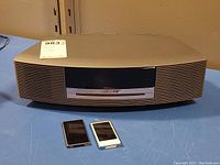 Front view of Bose Wave unit with two iPod Nanos in front