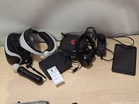 All items overview including VR headset, motion controller, processor unit, Beats Solo3 headphones with case, tablet, cables, and adapters