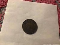 Front side of 1868 Shield Nickel coin showing shield design and date.