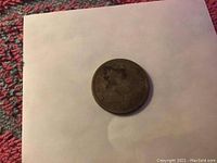 Obverse side of 1883 Liberty Head nickel showing the date 1883, signs of wear, portrait of Liberty head with crown and stars