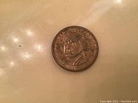 Clear view of the front side of the George Washington dollar coin showing portrait and date.