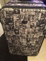 Front view of large suitcase showing black and white Michelle Obama photo collage design.