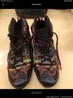 Front angle of the pair showing multi-color upper with black tongue and red swoosh accents.