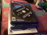 Stack of 4 PS4 game cases and a visible Marvel Avengers disc on top