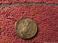 Philippines twenty centavos silver coin showing coat of arms side.