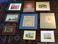Full view of all nine artworks laid out on carpet showing frames and variety of pieces