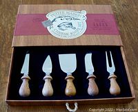 Full view of the Petite Maison cheese knife set in wooden box with five pieces securely placed.