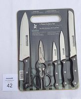 Photo of the 5 piece Gourmet cutlery set in original packaging showing four knives and one pair of scissors.