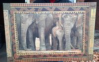 Front view of the canvas print featuring the elephant family with tribal border artwork.